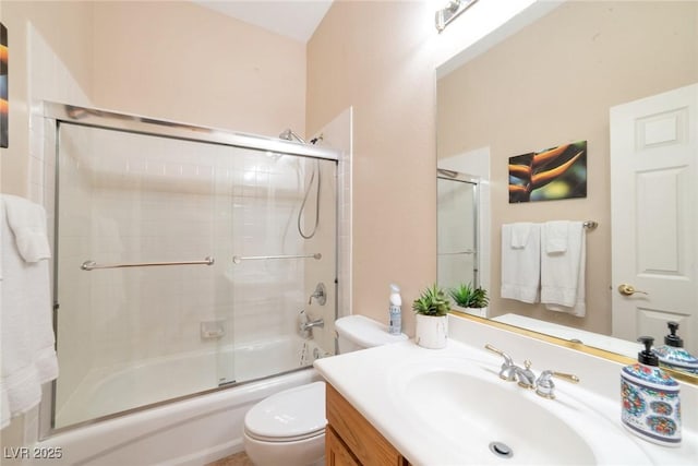 full bathroom featuring shower / bath combination with glass door, vanity, and toilet