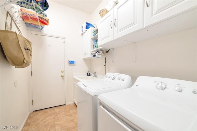 washroom featuring sink, washer and clothes dryer, and cabinets