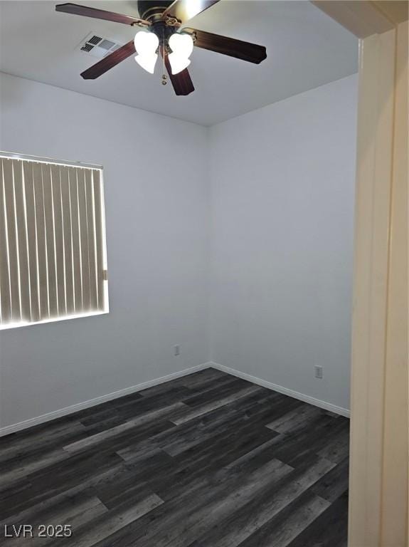 empty room featuring dark wood-type flooring and ceiling fan