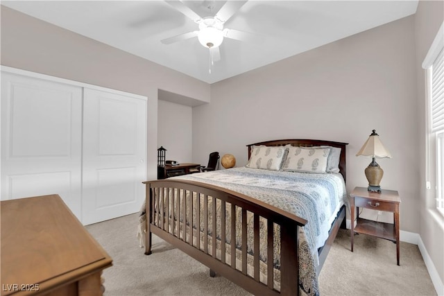 bedroom with light carpet, a closet, and ceiling fan