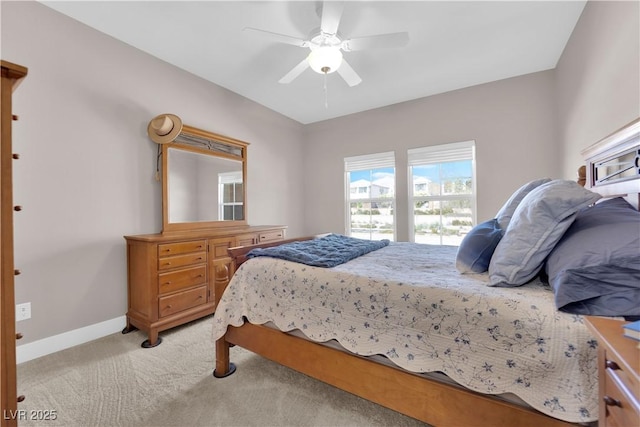 bedroom featuring light colored carpet and ceiling fan