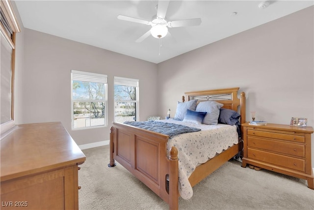 bedroom featuring light colored carpet and ceiling fan