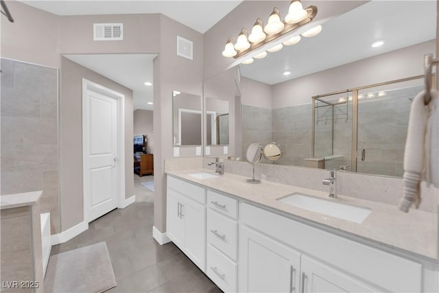 bathroom with vanity, an enclosed shower, and tile patterned floors