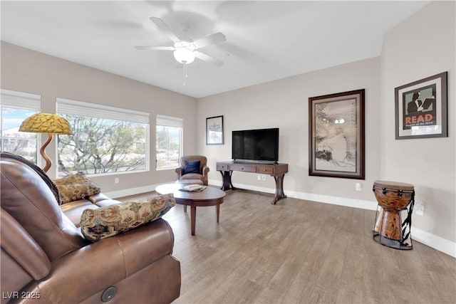 living room featuring light hardwood / wood-style flooring and ceiling fan