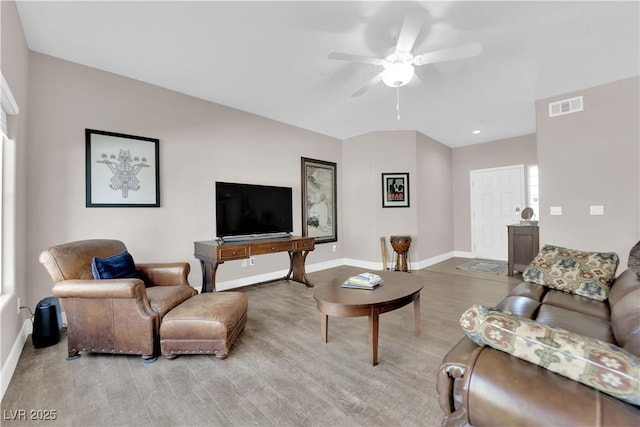 living room featuring light hardwood / wood-style flooring and ceiling fan