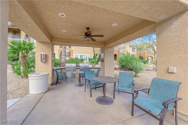 view of patio / terrace featuring an outdoor kitchen, area for grilling, and ceiling fan