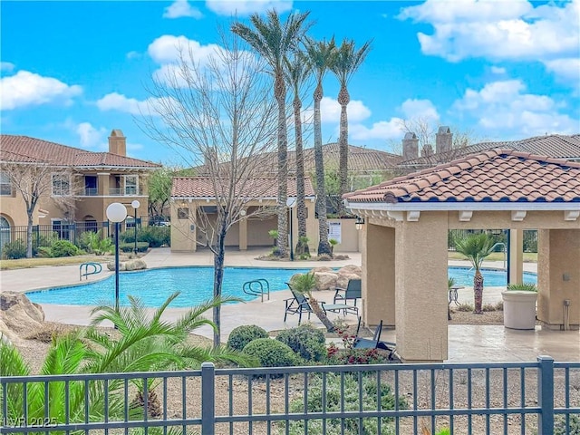 view of pool featuring a patio, a water view, and a gazebo