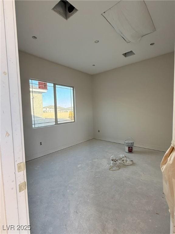 spare room featuring concrete flooring