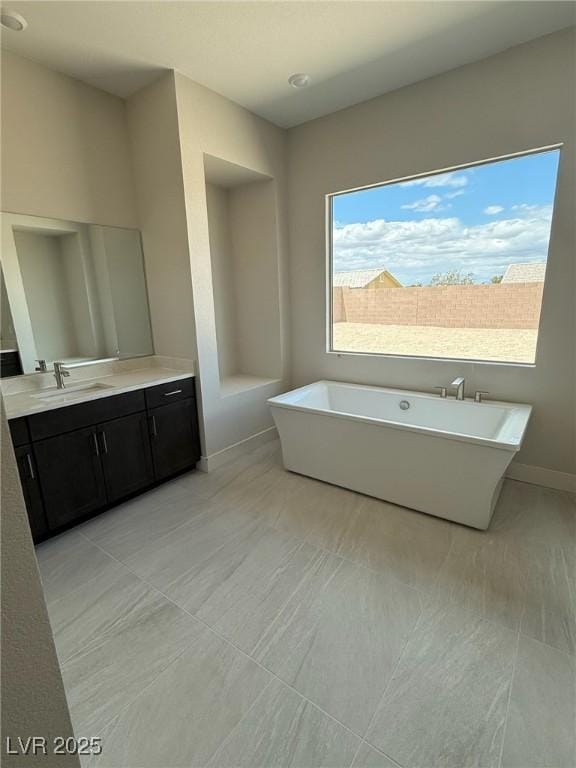 4630 Blushing Dawn Ave, Las Vegas, NV 89118 - bathroom featuring vanity, a freestanding bath, baseboards, and tile patterned floors