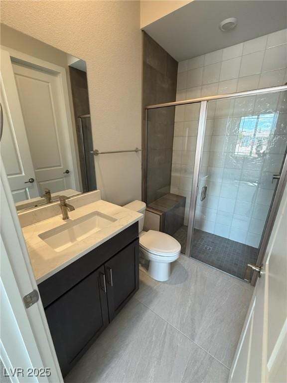 4630 Blushing Dawn Ave, Las Vegas, NV 89118 - full bathroom featuring a shower stall, vanity, toilet, and tile patterned flooring