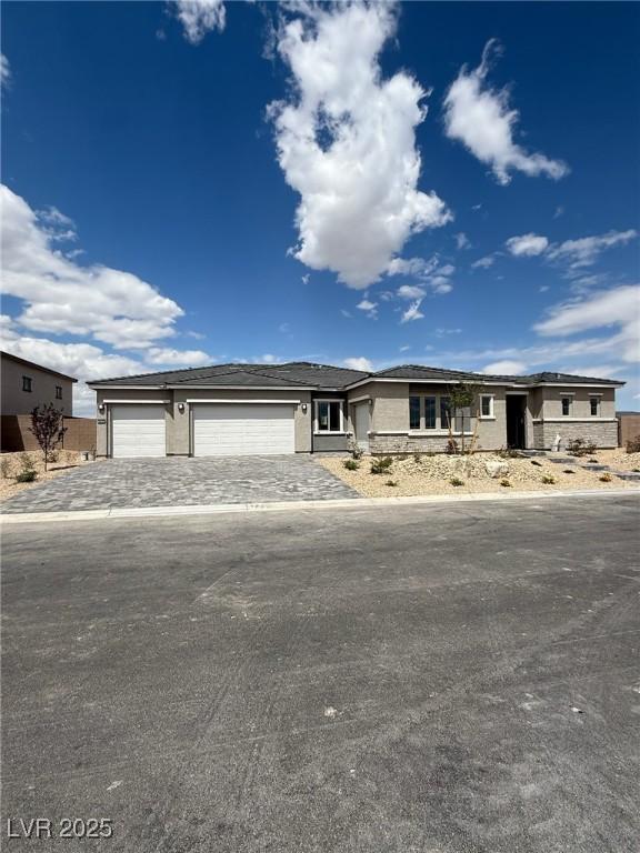 4630 Blushing Dawn Ave, Las Vegas, NV 89118 - prairie-style house featuring a garage and driveway