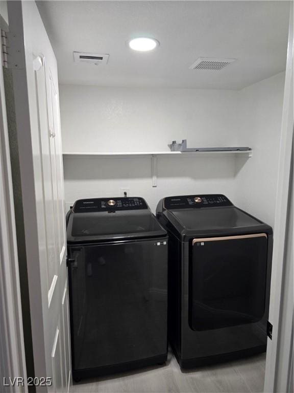 laundry room featuring independent washer and dryer