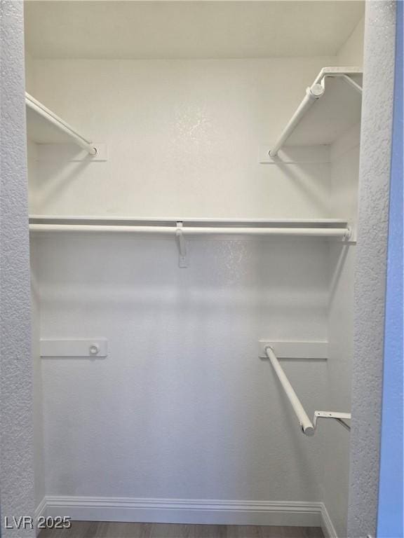 walk in closet featuring wood-type flooring