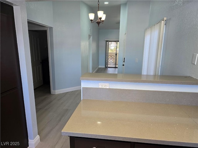 bathroom with an inviting chandelier and hardwood / wood-style floors