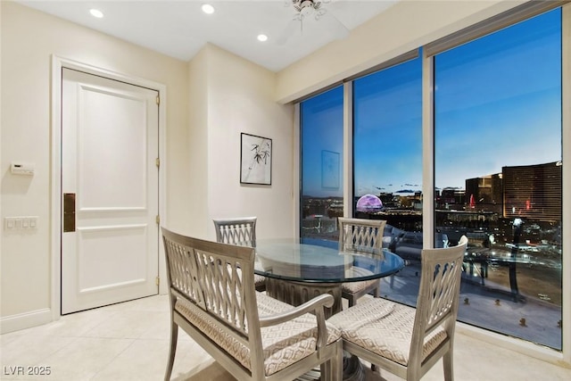 tiled dining area featuring ceiling fan