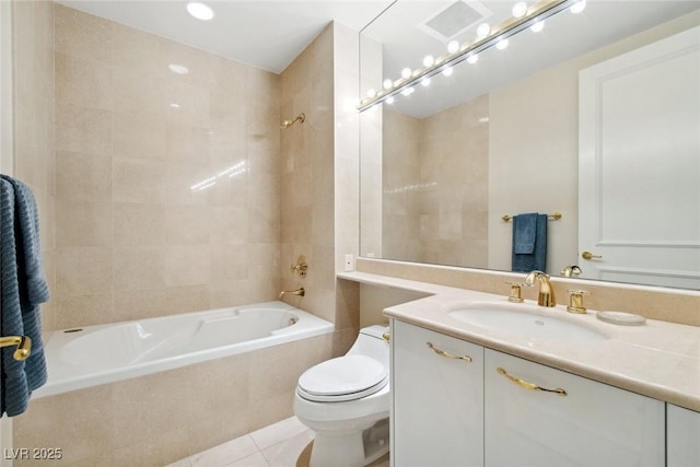 full bathroom featuring tiled shower / bath combo, vanity, tile patterned flooring, and toilet