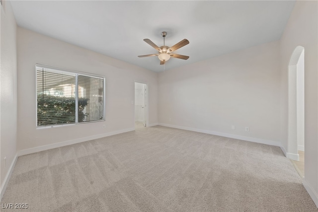 carpeted spare room featuring ceiling fan