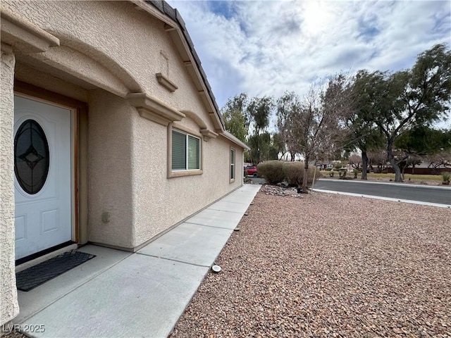 view of side of property with stucco siding