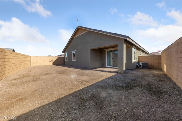 rear view of house featuring cooling unit