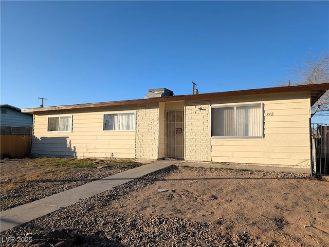 single story home featuring fence