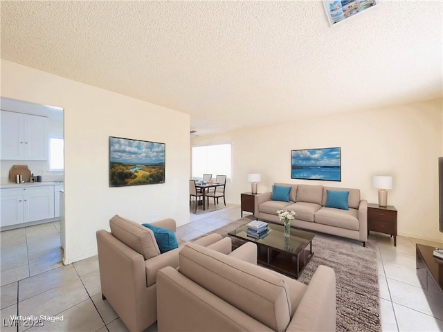 living room featuring a textured ceiling and light tile patterned floors