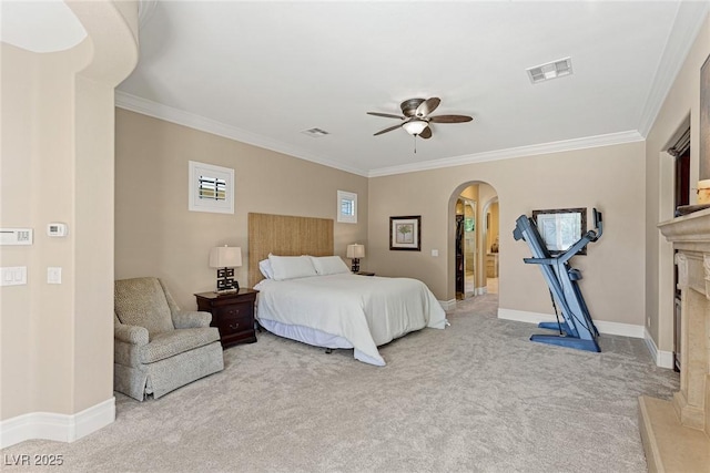 bedroom featuring light carpet, crown molding, ceiling fan, and a spacious closet