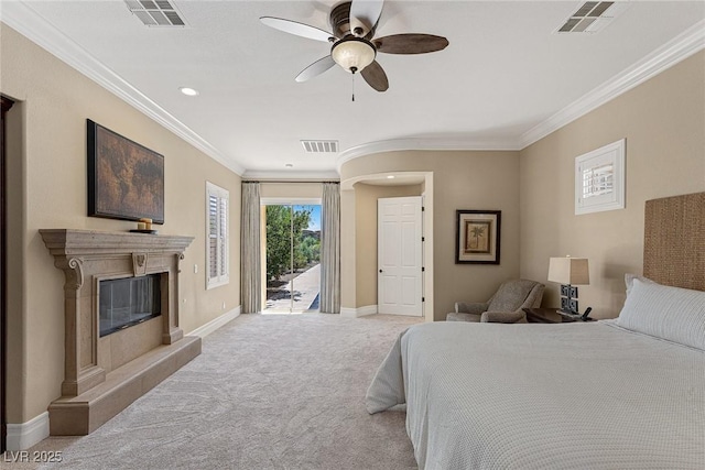 bedroom with ceiling fan, a high end fireplace, ornamental molding, light carpet, and access to outside