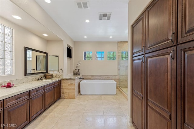 bathroom featuring tile patterned floors, vanity, and separate shower and tub