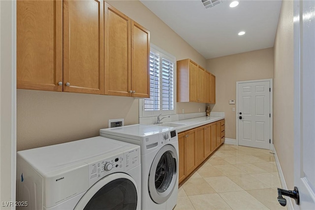 washroom with cabinets, washer and clothes dryer, sink, and light tile patterned floors