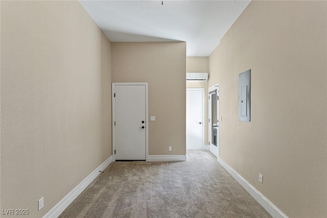 hallway with an AC wall unit, carpet flooring, and electric panel