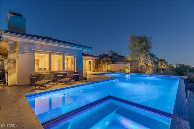 view of swimming pool with an in ground hot tub and a patio area