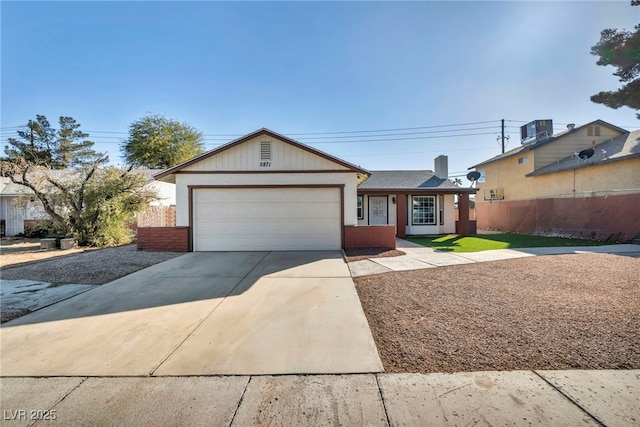 ranch-style house featuring cooling unit and a garage