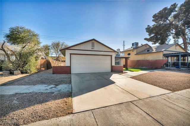 ranch-style home featuring a garage, an outdoor structure, and central AC unit