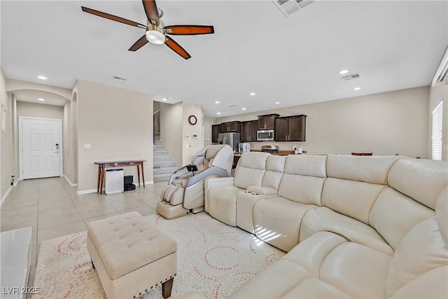 tiled living room featuring ceiling fan