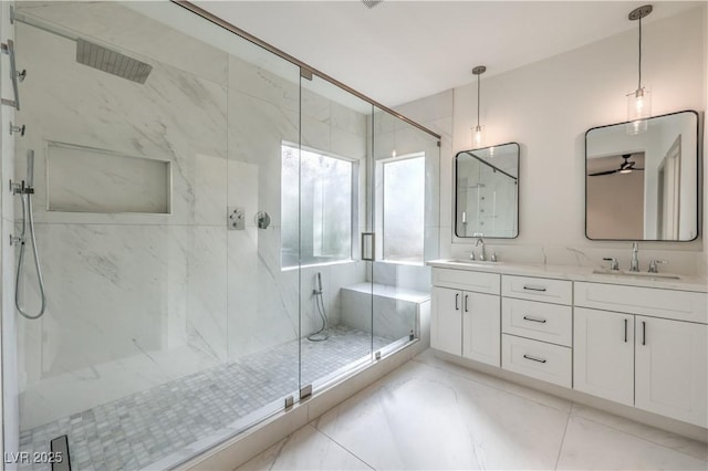 bathroom featuring double vanity, a sink, and a marble finish shower