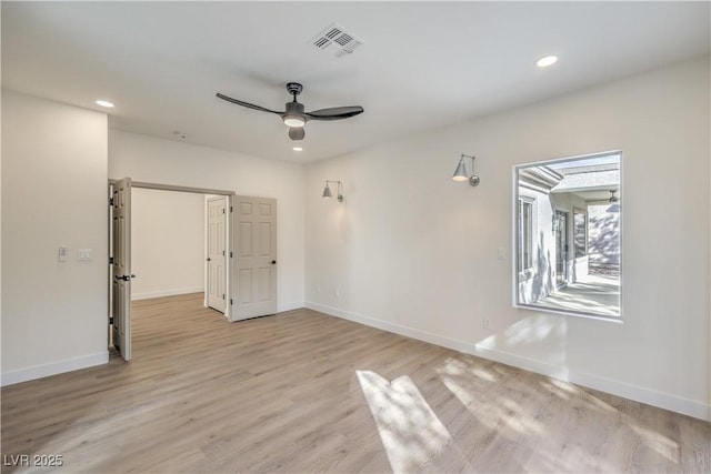 unfurnished room with recessed lighting, baseboards, visible vents, and light wood finished floors