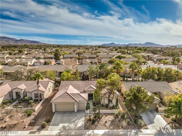 drone / aerial view featuring a residential view and a mountain view