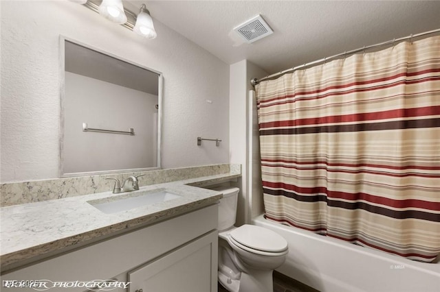 full bathroom featuring shower / bathtub combination with curtain, vanity, toilet, and a textured ceiling