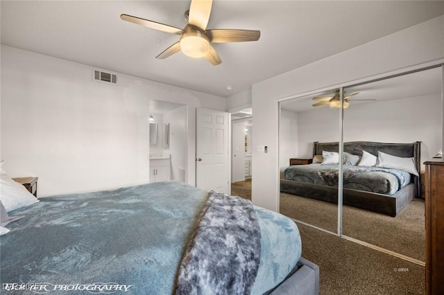 carpeted bedroom with ceiling fan and a closet