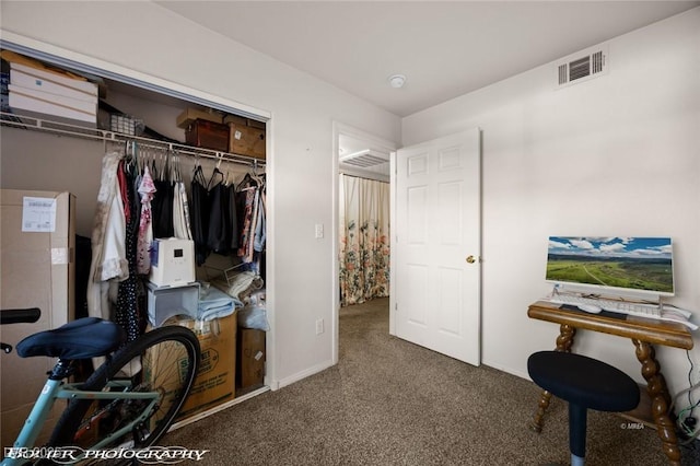 interior space featuring dark carpet and a closet