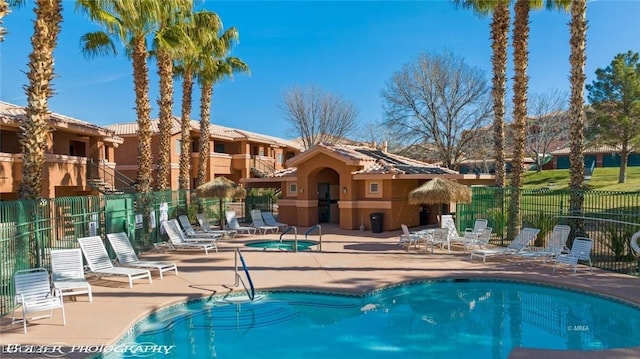 view of pool featuring a community hot tub and a patio