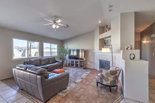 living room featuring ceiling fan, tile patterned floors, a fireplace, and vaulted ceiling