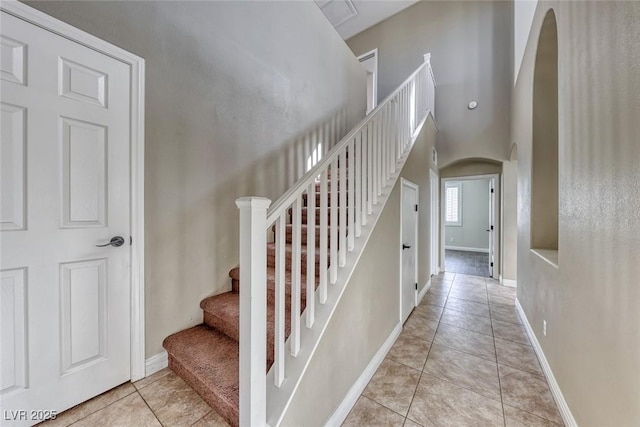 staircase featuring tile patterned flooring