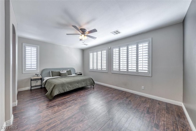 bedroom featuring multiple windows, ceiling fan, and dark hardwood / wood-style flooring