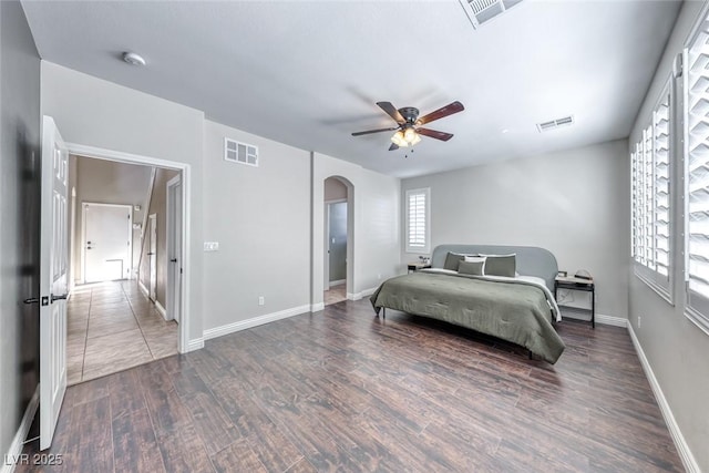 bedroom with ceiling fan and dark hardwood / wood-style floors