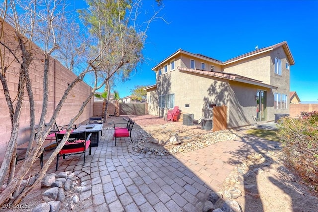 exterior space with central AC unit and a patio