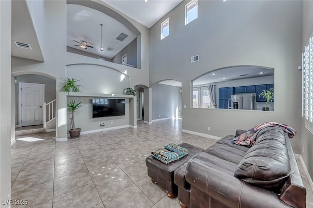 tiled living room with ceiling fan