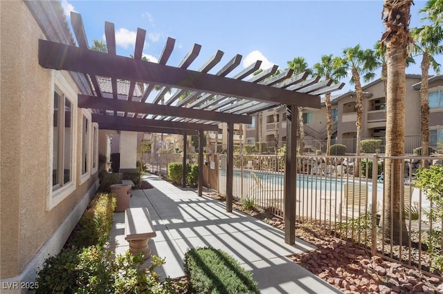 view of patio / terrace with a community pool and a pergola