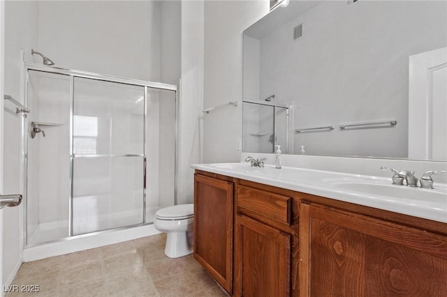 bathroom with walk in shower, vanity, and toilet