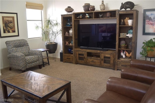 carpeted living area featuring baseboards